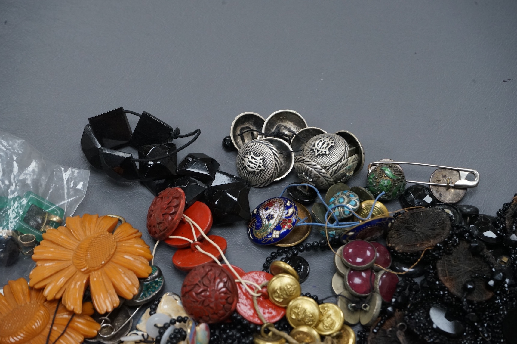 A collection of late 19th and 20th century buttons, some novelty, made from varying materials, metal, bakelite and glass.